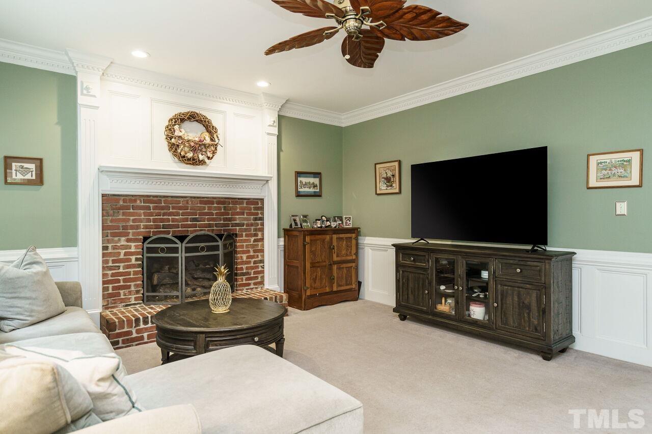 7800 Laurel Mountain Road Raleigh, NC 27613 - Photo 12 of 31 a living room with furniture and a flat screen tv