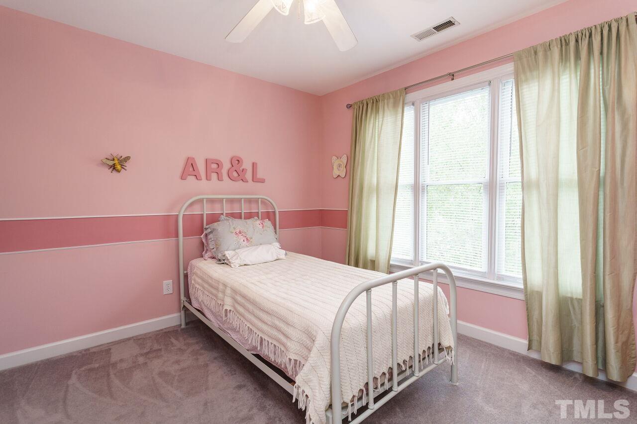 7800 Laurel Mountain Road Raleigh, NC 27613 - Photo 18 of 31 a bedroom with a bed and a window