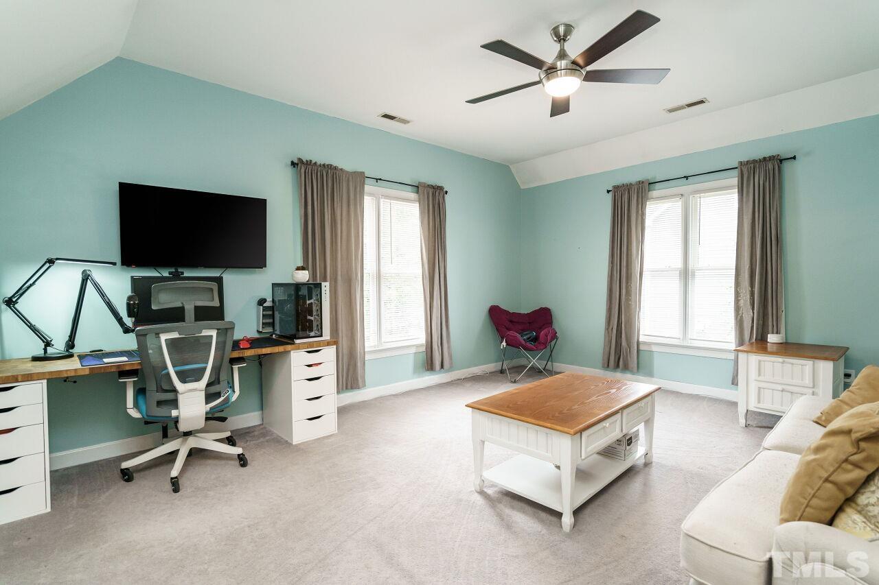 7800 Laurel Mountain Road Raleigh, NC 27613 - Photo 22 of 31 a living room with furniture and a flat screen tv