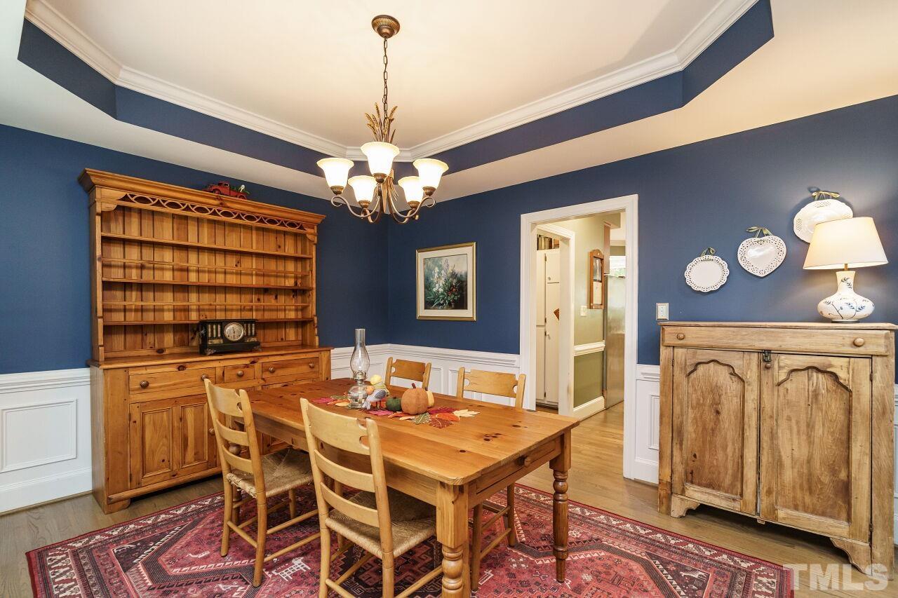 7800 Laurel Mountain Road Raleigh, NC 27613 - Photo 4 of 31 a dining room with furniture a chandelier and window