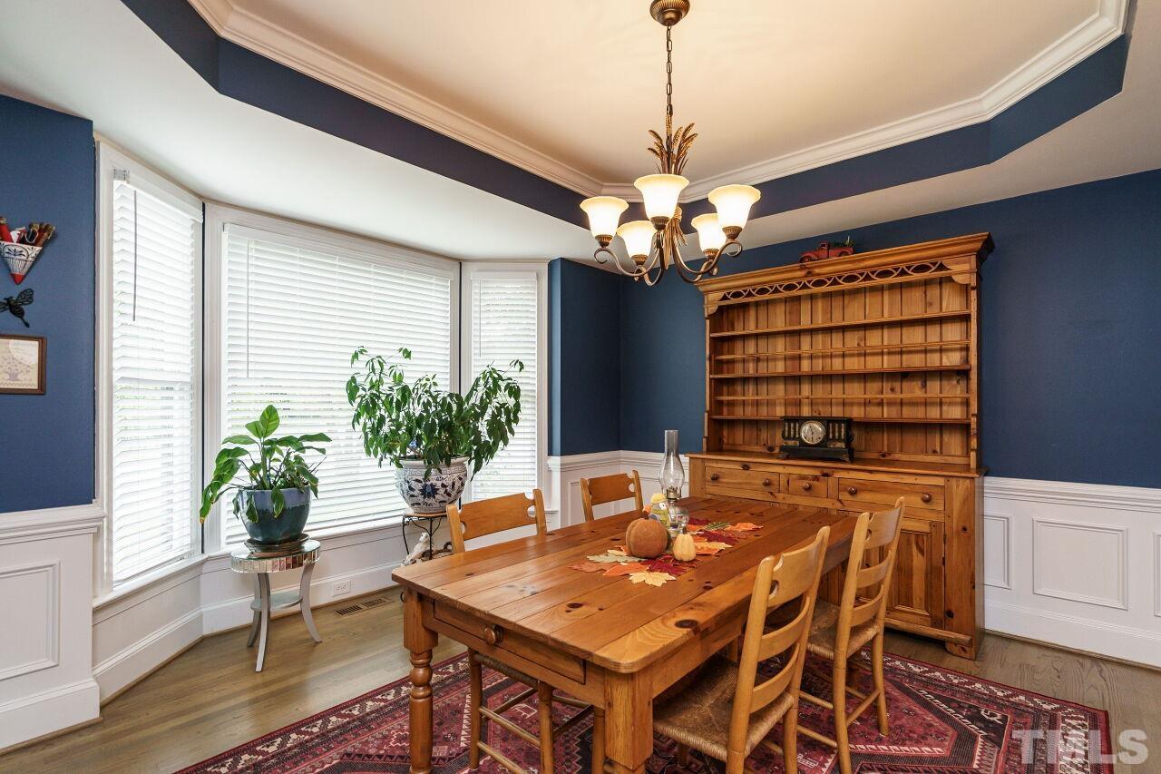 7800 Laurel Mountain Road Raleigh, NC 27613 - Photo 5 of 31 a view of a dining room with furniture window and wooden floor