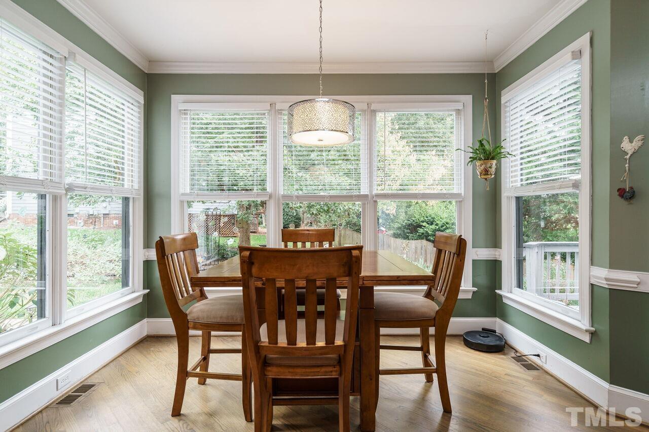 7800 Laurel Mountain Road Raleigh, NC 27613 - Photo 10 of 31 a view of a dining room with furniture window and wooden floor