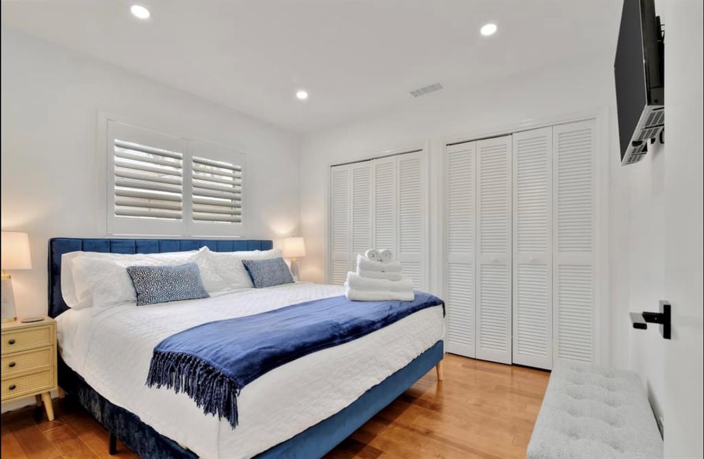 105 Orchard Ridge Lane Boca Raton, FL 33431 - Photo 12 of 24 a bedroom with a bed and flat screen tv