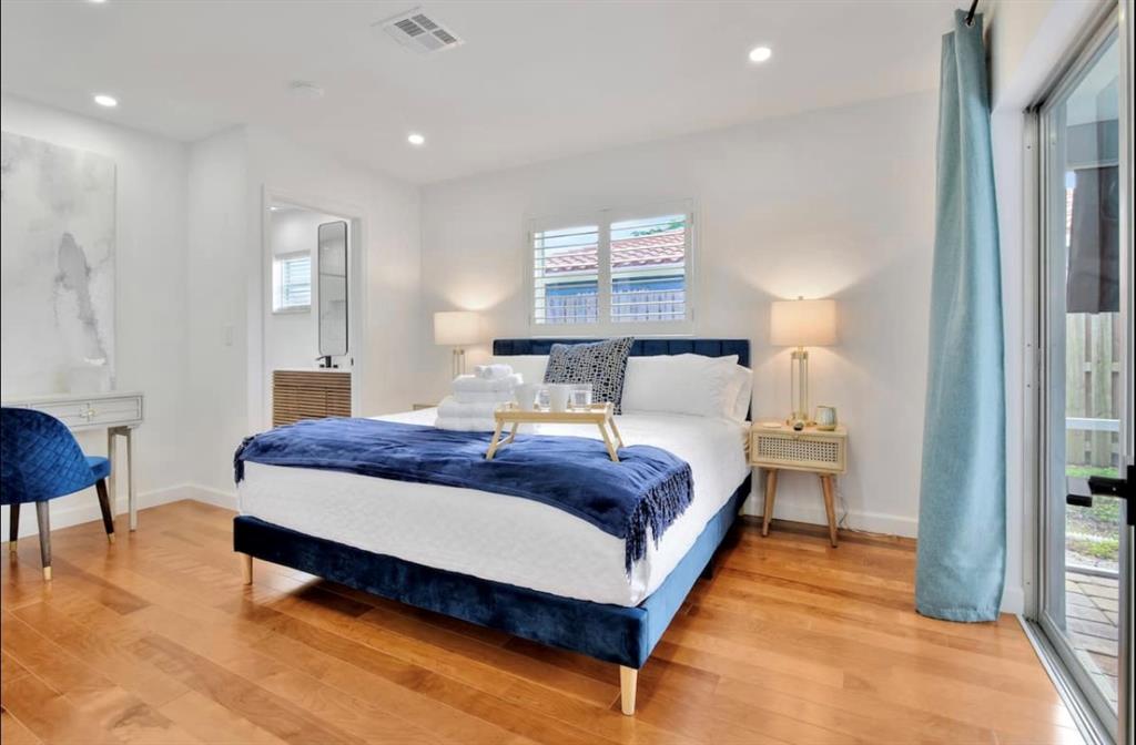 105 Orchard Ridge Lane Boca Raton, FL 33431 - Photo 16 of 24 a bedroom with a bed a lamp and a large window