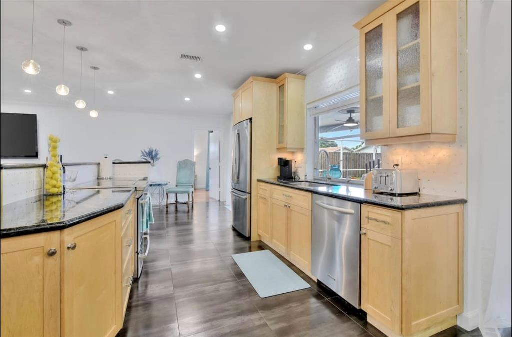 105 Orchard Ridge Lane Boca Raton, FL 33431 - Photo 8 of 24 a kitchen with stainless steel appliances granite countertop a sink counter space and cabinets