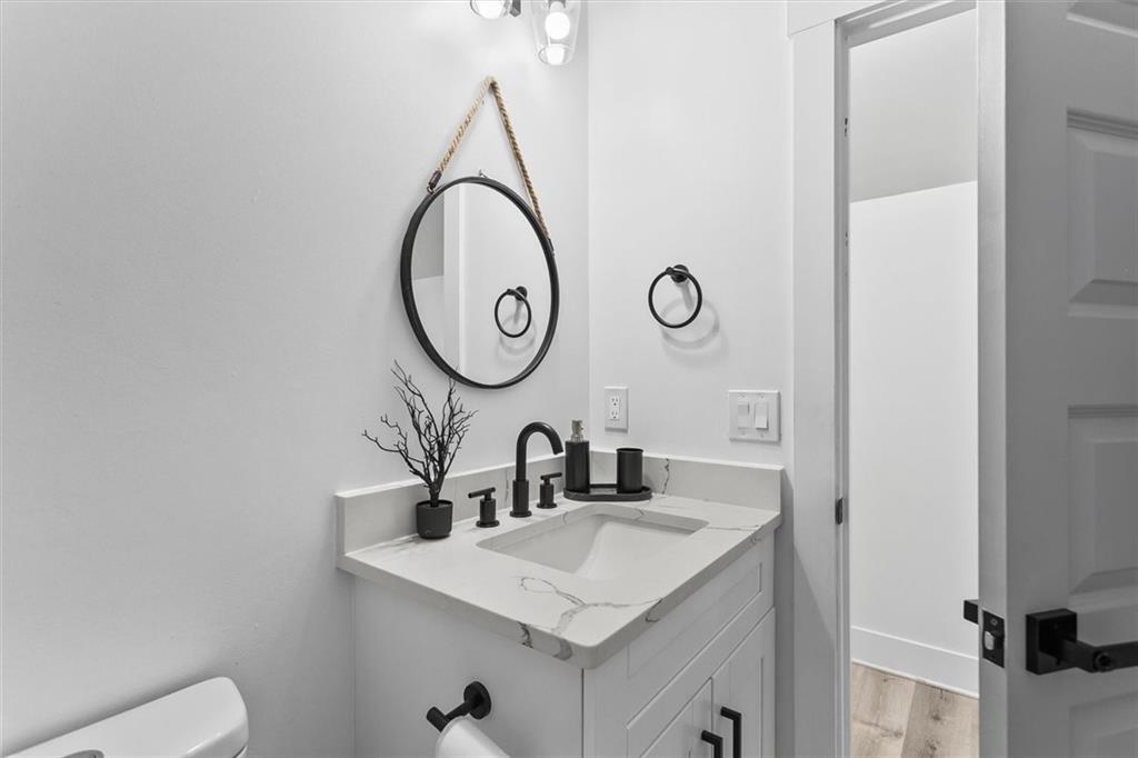 658 Rockbridge Road Northwest Lilburn, GA 30047 - Photo 9 of 61 a bathroom with a sink and a mirror