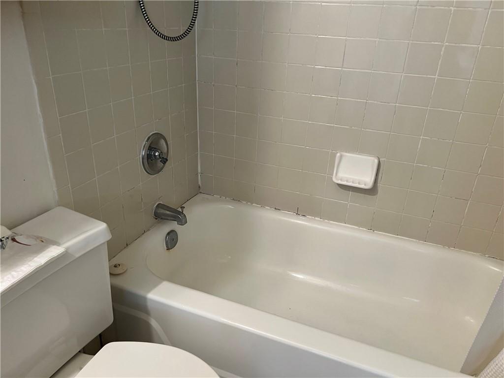 3256 Kennett Square Pittsburgh, PA 15213 - Photo 10 of 15 a white bath tub sitting next to a white toilet and a sink