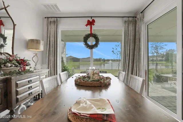 a bedroom with a bed a dresser and painting on the wall