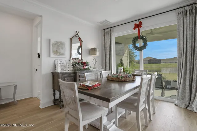 a bedroom with a bed a dresser and painting on the wall