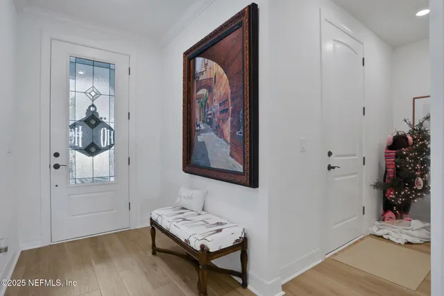 a living room with patio furniture and a floor to ceiling window