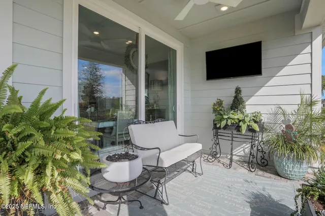 a view of a house with a yard and potted plants