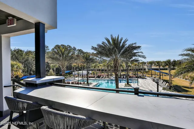 a view of a swimming pool with outdoor seating
