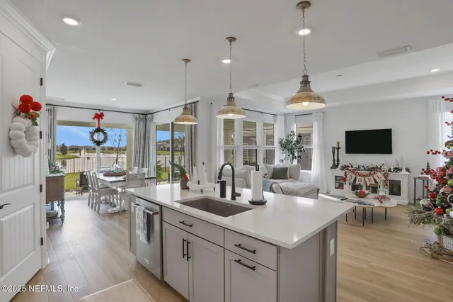 a kitchen with white cabinets and stove