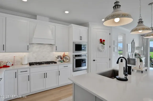 a kitchen with stainless steel appliances a sink stove and refrigerator