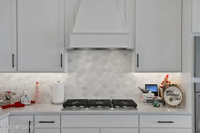a kitchen with stainless steel appliances a stove and a refrigerator