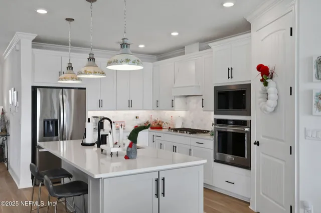 a kitchen with a sink stove and refrigerator