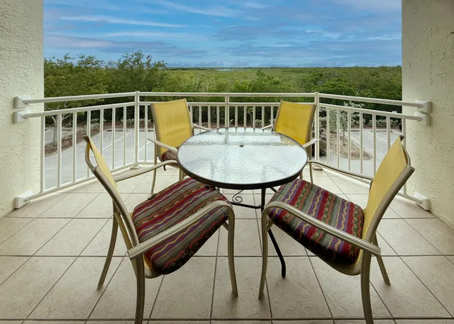 a view of a balcony with chairs
