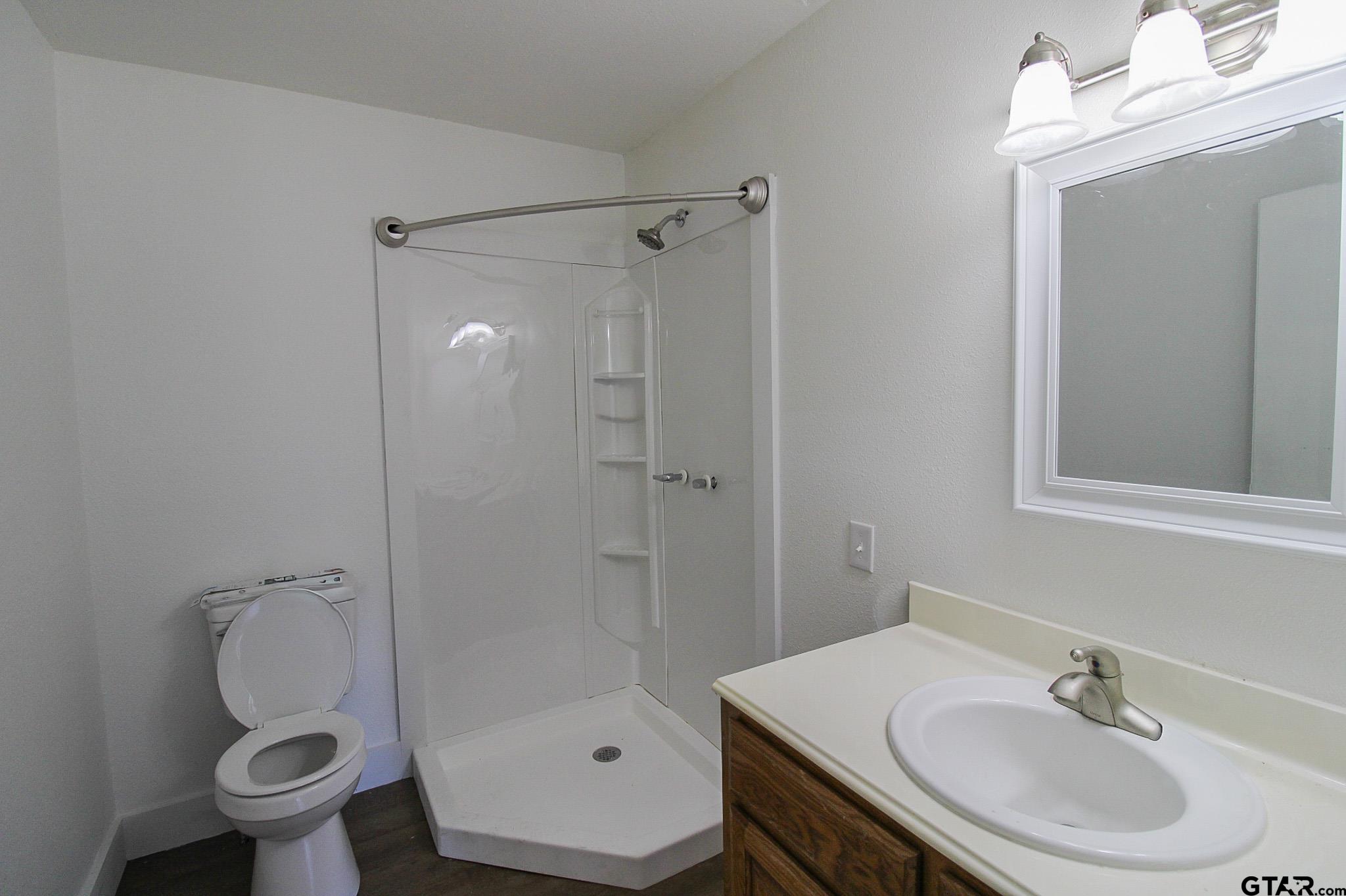 407 Pace Street Naples, TX 75568 - Photo 23 of 31 a bathroom with a sink toilet and shower