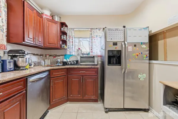 a kitchen with stainless steel appliances granite countertop a refrigerator and microwave