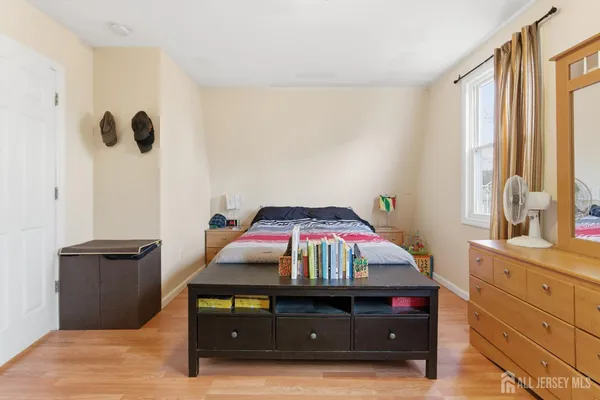 a view of a bedroom with a bed and a window