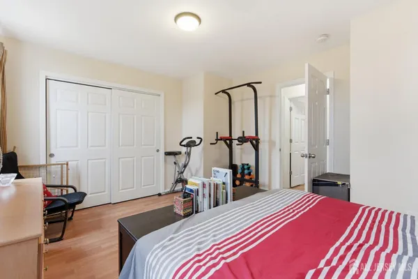 a bedroom with a bed and a closet