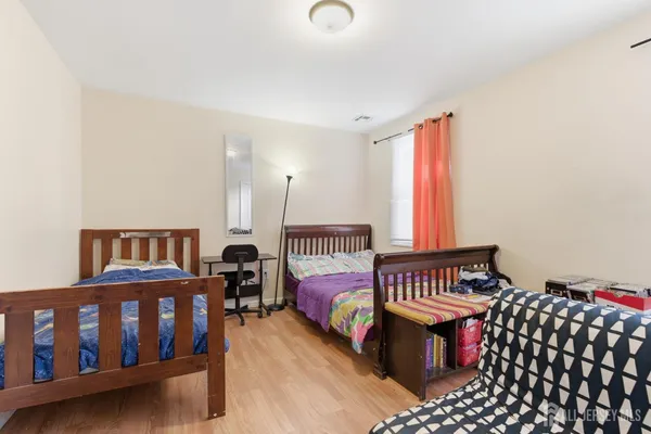 a bedroom with furniture and a window