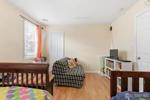 a bedroom with furniture and a window