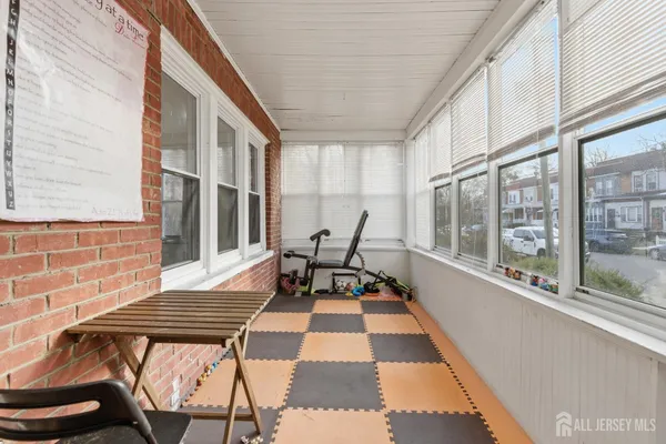 a view of balcony with two chairs and a rug