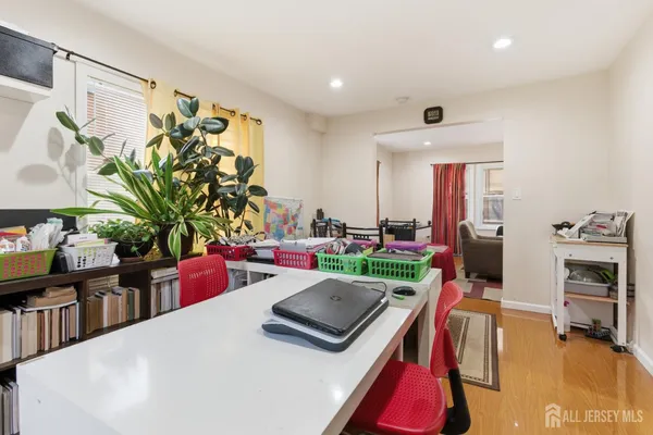 a living room with furniture flat screen tv and a large window