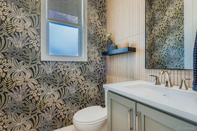a bathroom with a sink a toilet and shower curtain