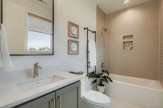 a bathroom with a sink toilet tub and shower