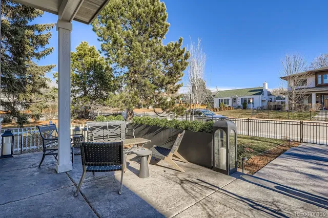 a view of a patio with table and chairs and potted plants