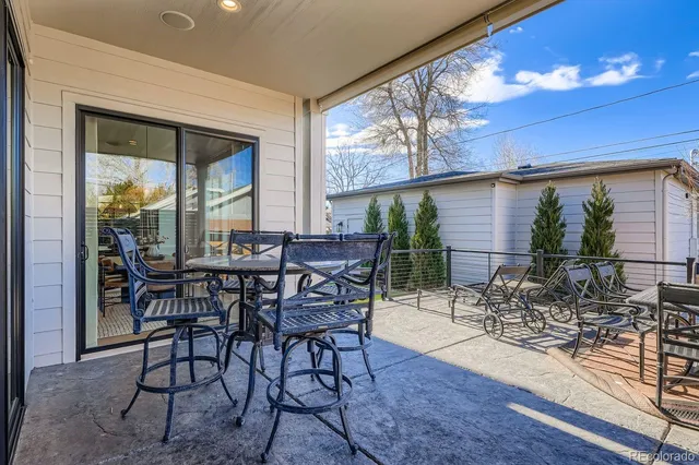 a view of a patio with table and chairs