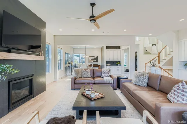 a living room with furniture a flat screen tv and a fireplace
