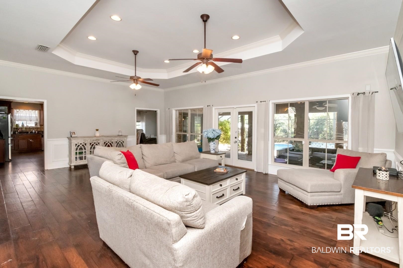 27890 Rileywood Drive Daphne, AL 36526 - Photo 9 of 49 Living area with a ceiling fan, dark wood-style floors, and a raised ceiling