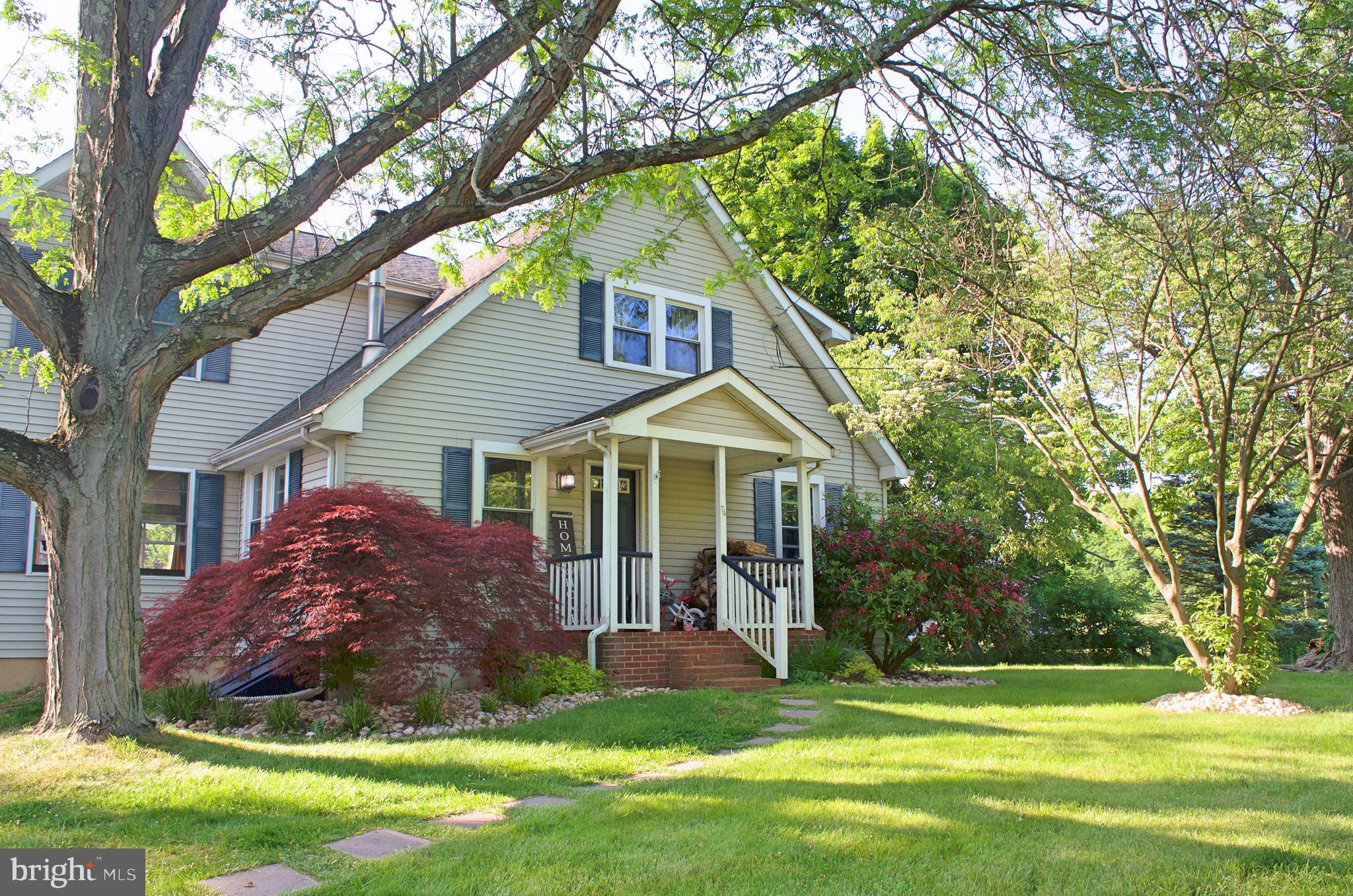 a front view of a house with a yard porch and wooden fence