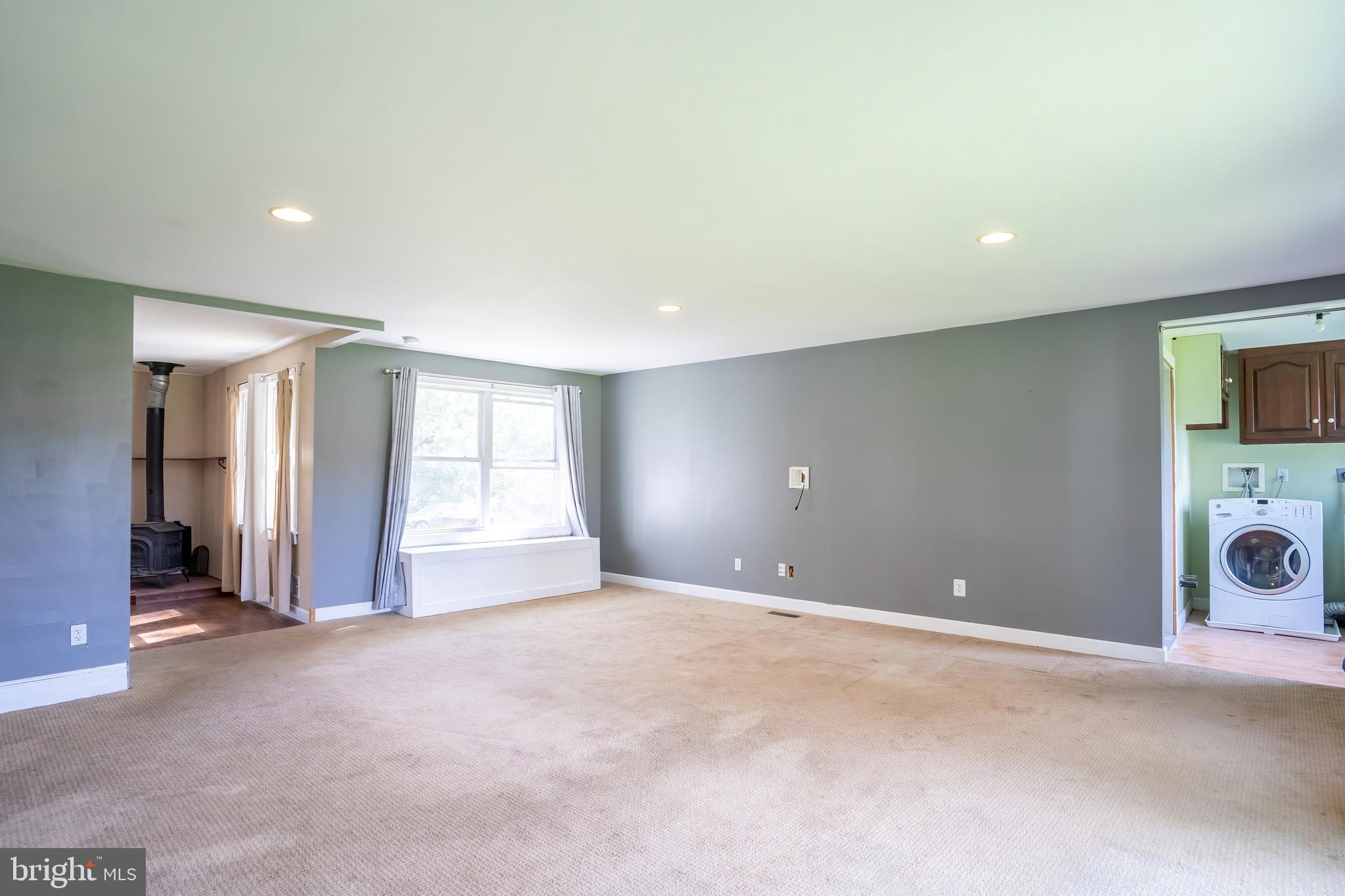 74 Woods Road Hightstown, NJ 08520 - Photo 14 of 57 a view of a livingroom with a fireplace and a window