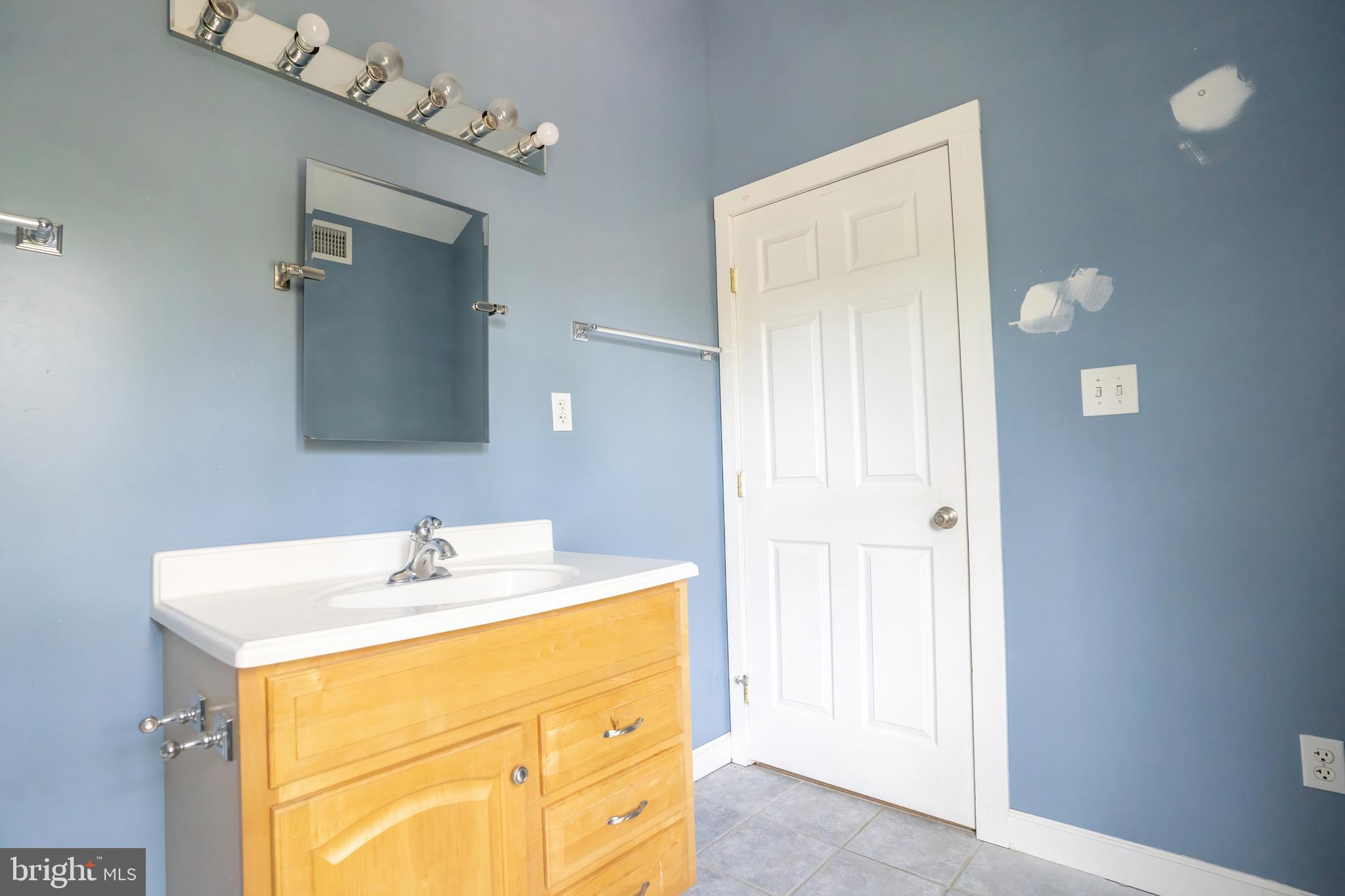 74 Woods Road Hightstown, NJ 08520 - Photo 26 of 57 a bathroom with a sink a vanity and a mirror