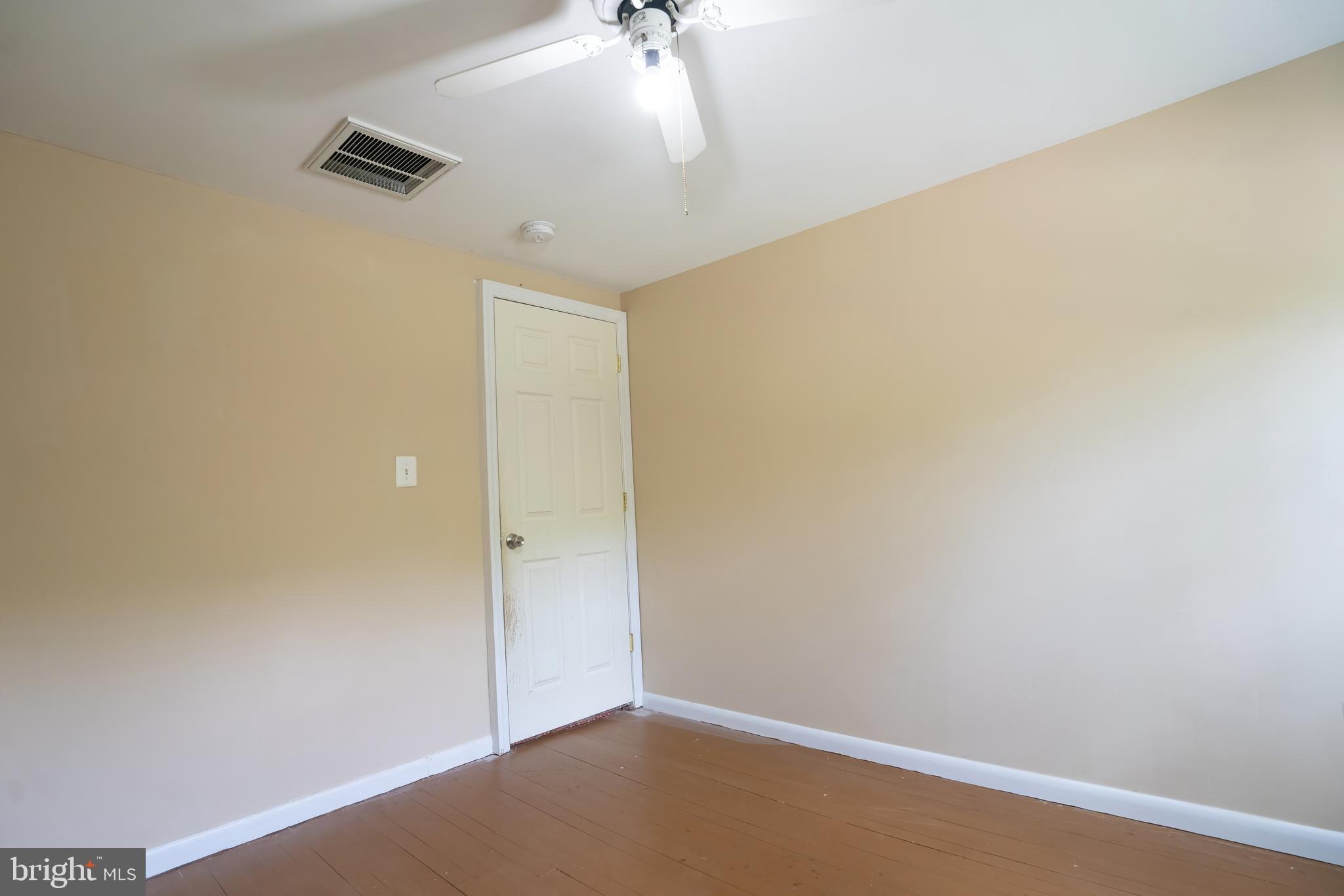 74 Woods Road Hightstown, NJ 08520 - Photo 38 of 57 an empty room with a ceiling fan and a window