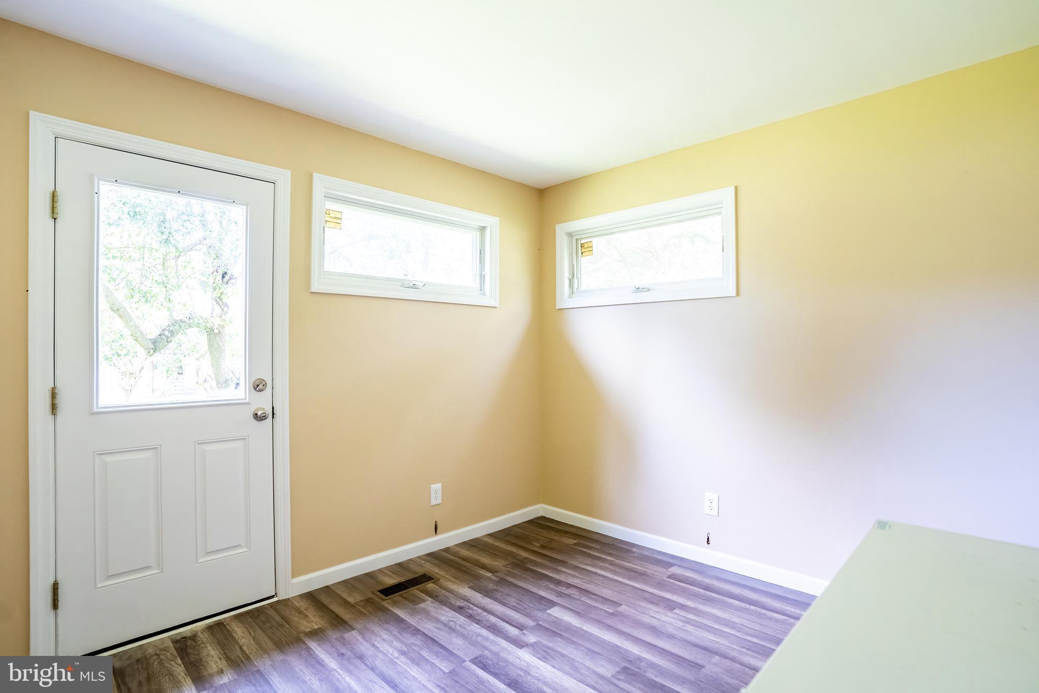 74 Woods Road Hightstown, NJ 08520 - Photo 43 of 57 a view of an empty room with wooden floor and a window
