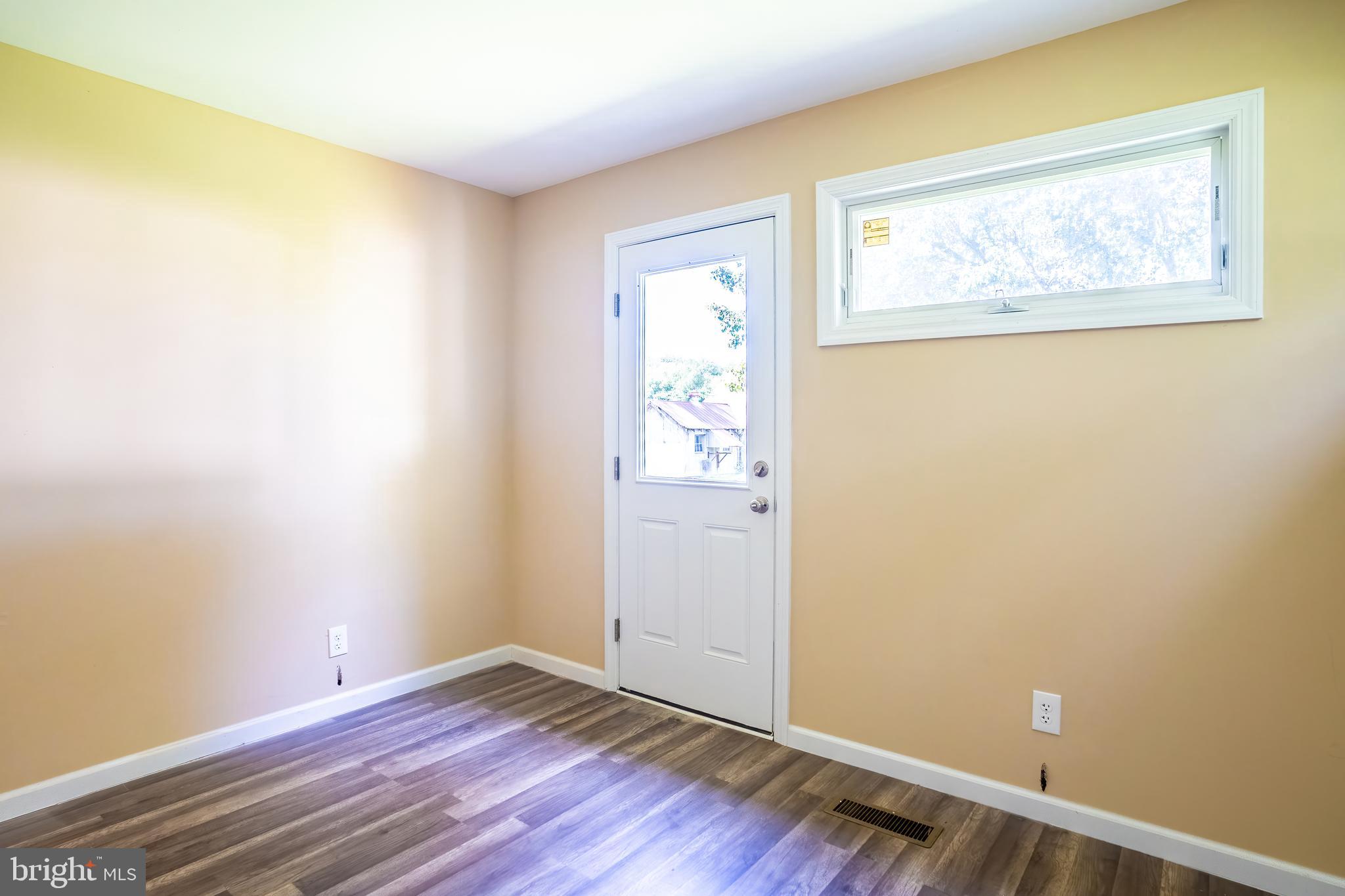 74 Woods Road Hightstown, NJ 08520 - Photo 44 of 57 a view of an empty room with wooden floor and a window