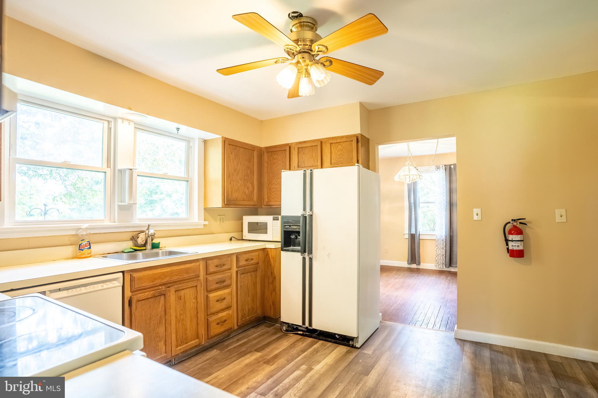 74 Woods Road Hightstown, NJ 08520 - Photo 49 of 57 a kitchen with a refrigerator a sink and dishwasher with wooden floor