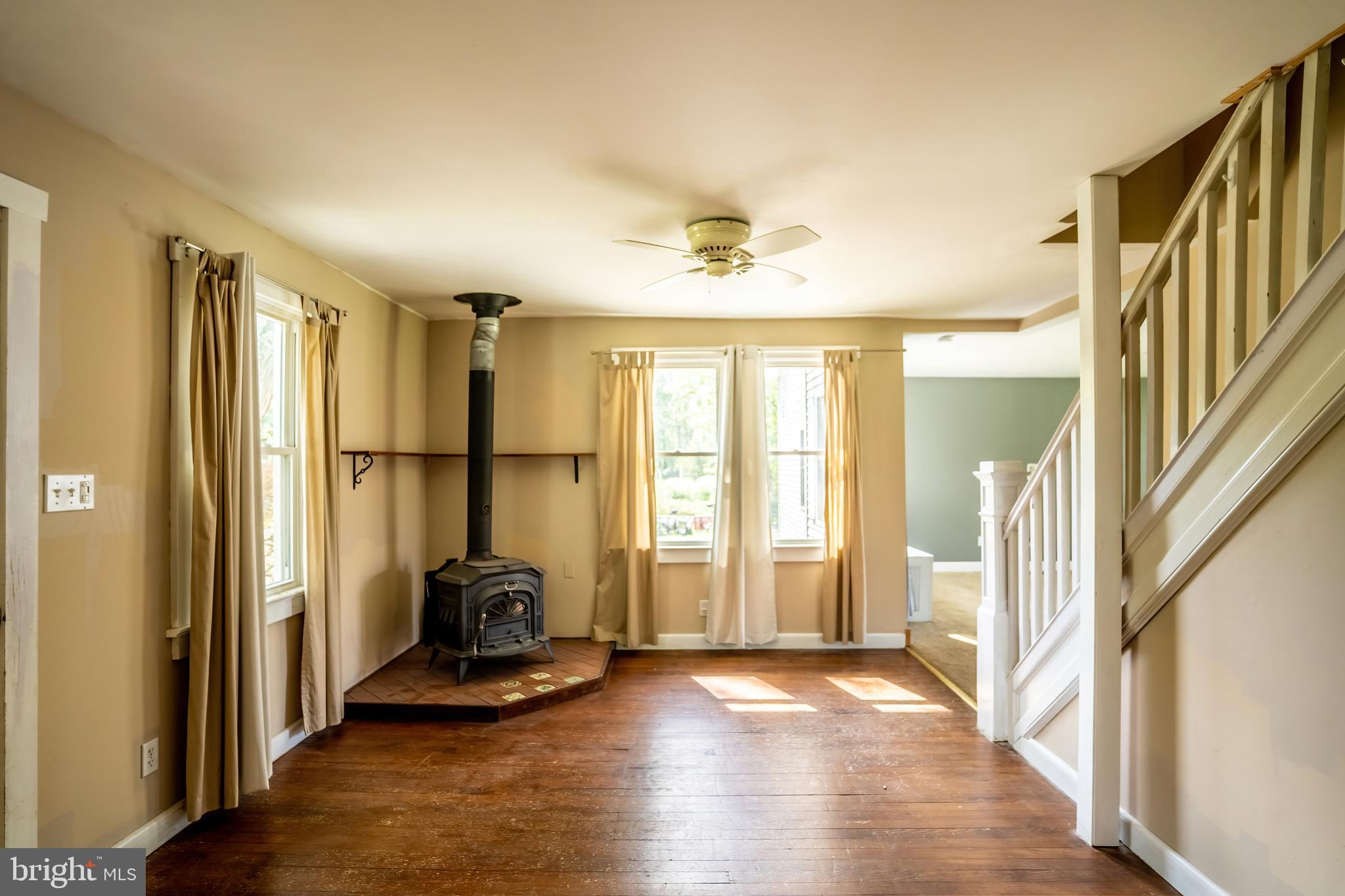 74 Woods Road Hightstown, NJ 08520 - Photo 5 of 57 a view of a hallway with wooden floor and staircase