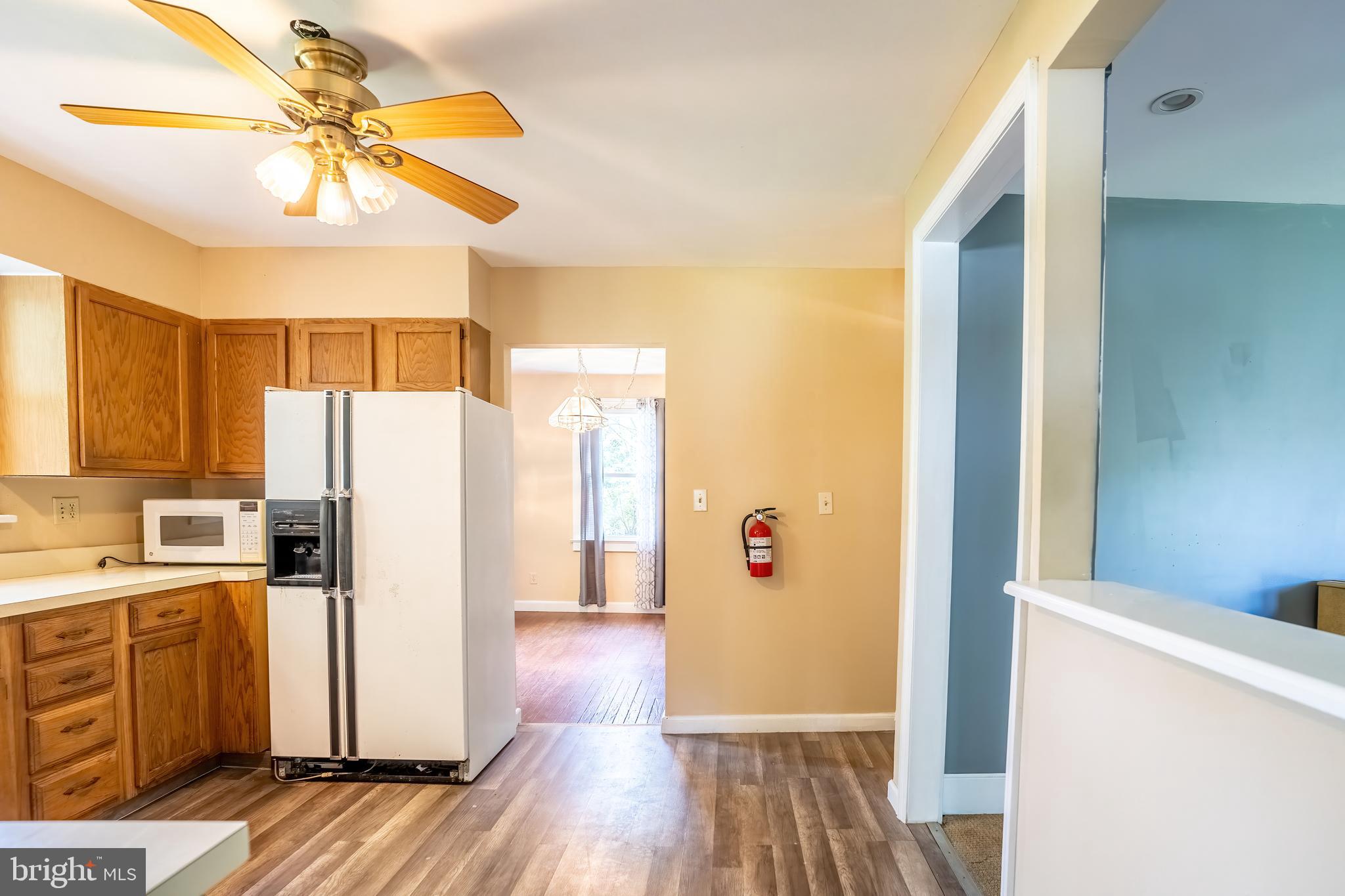 74 Woods Road Hightstown, NJ 08520 - Photo 55 of 57 a kitchen with a refrigerator a sink and cabinets