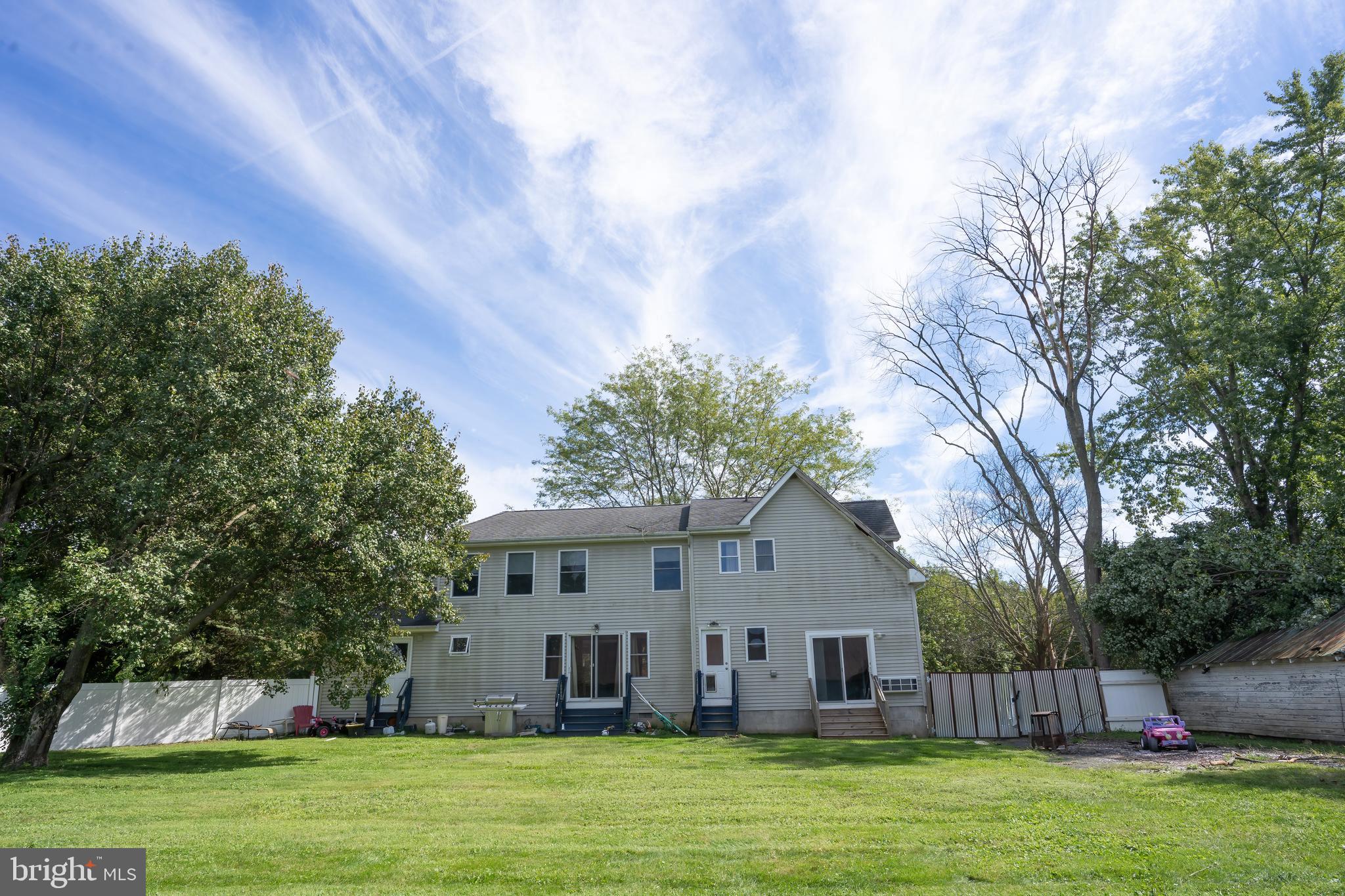 74 Woods Road Hightstown, NJ 08520 - Photo 57 of 57 a front view of a house with a garden and trees