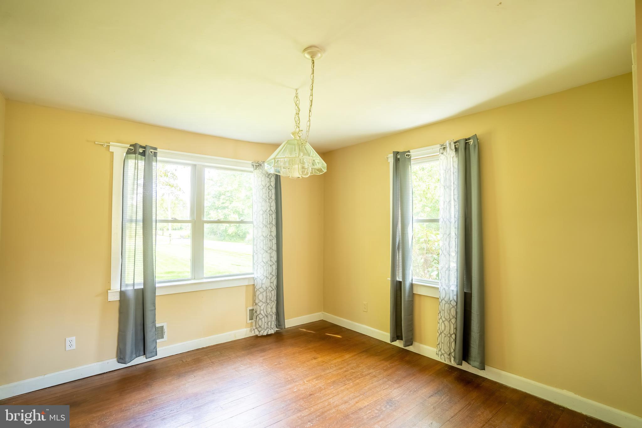 74 Woods Road Hightstown, NJ 08520 - Photo 7 of 57 an empty room with wooden floor and windows