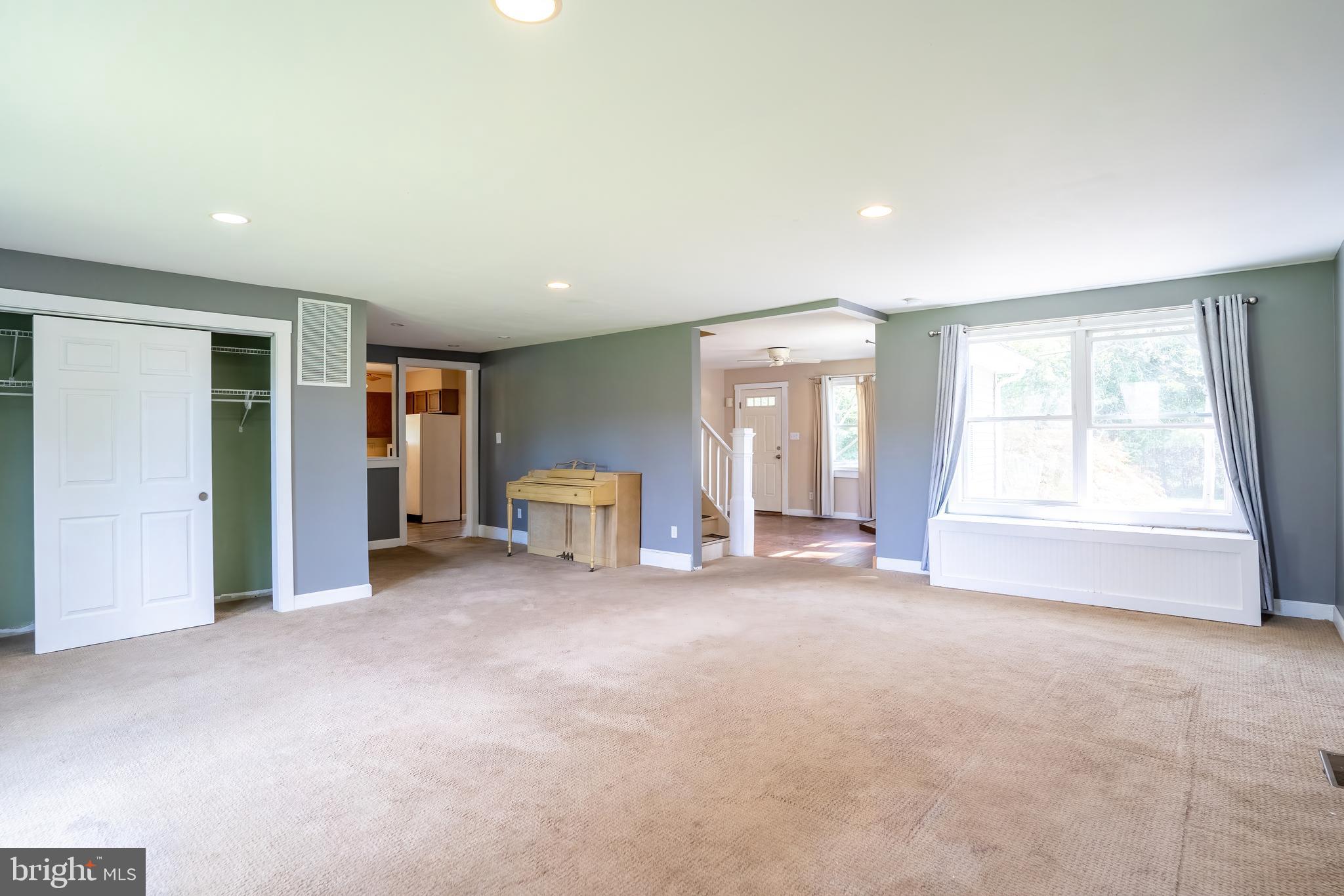 74 Woods Road Hightstown, NJ 08520 - Photo 8 of 57 a view of an empty room with window and a kitchen