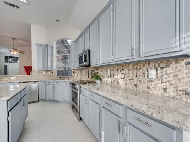 a kitchen with sink cabinets and appliances