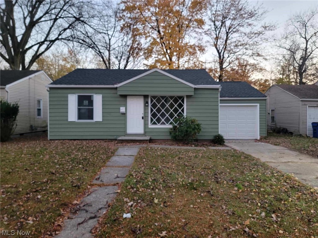 2052 North Green Road Cleveland, OH 44121 - Photo 1 of 13 View of front of property featuring a garage and a front lawn