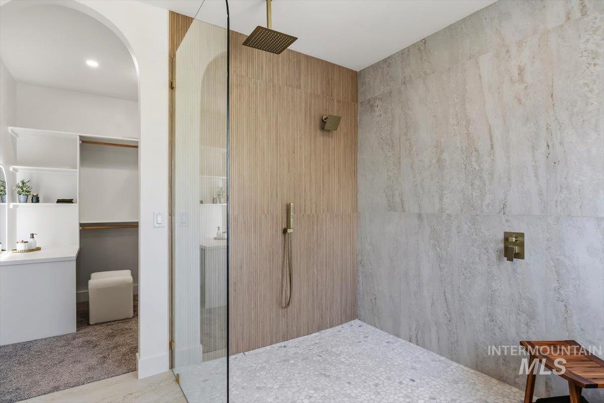 2005 Sparrow Street Rupert, ID 83350 - Photo 19 of 30 Glass-enclosed shower featuring a rain showerhead, hand-held shower, and integrated shower controls in a gold-toned finish